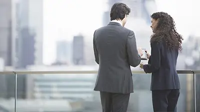 Two young business people working together on a rooftop