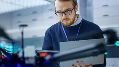 A man in an office looking at a computer